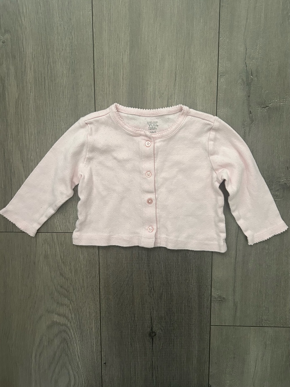 Light pink baby cardigan featuring a button-down front: 6 months